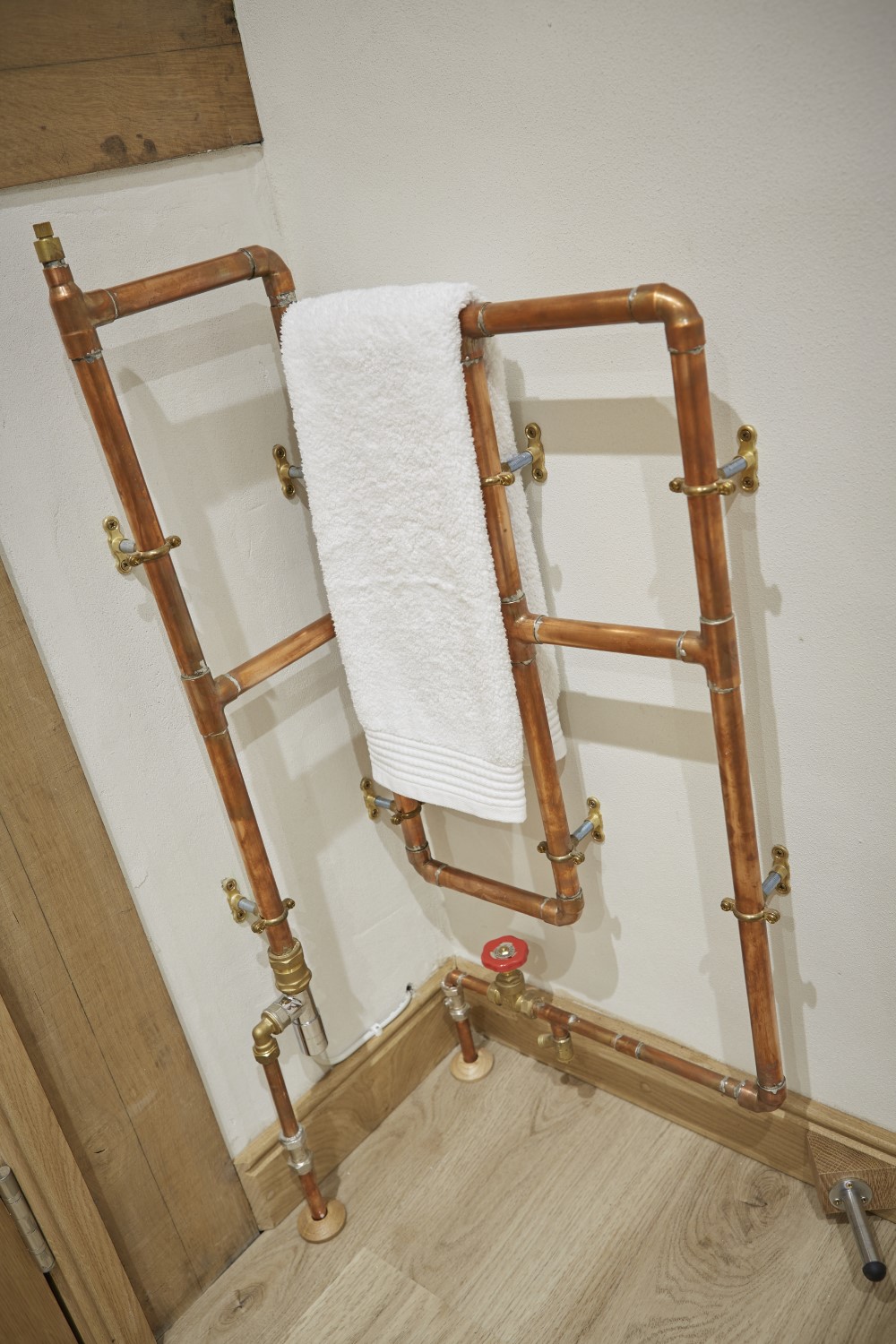 A towel rail in the ensuite bathroom, made out of copper piping